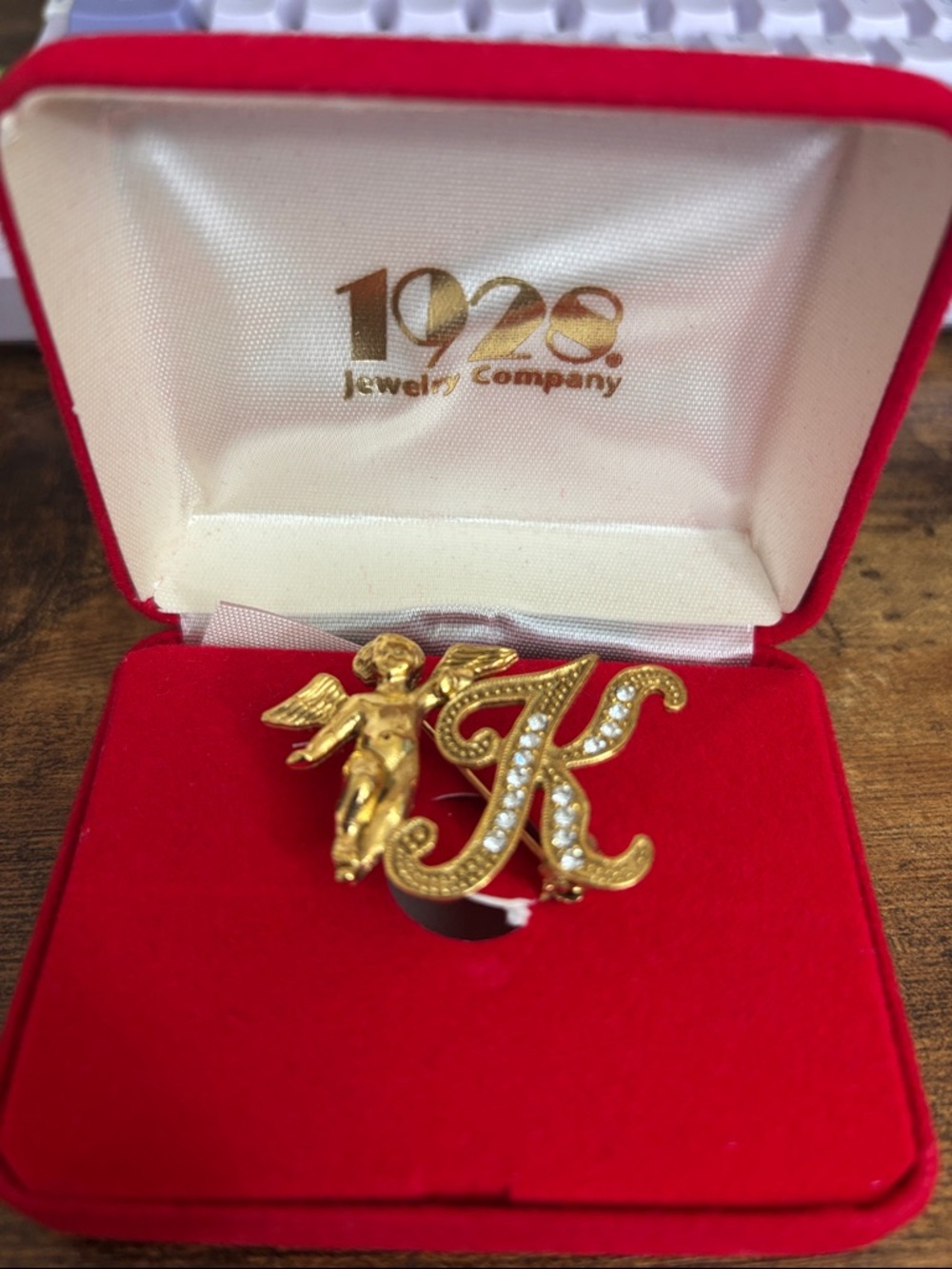 1928 Gold-Tone 'K' Script Brooch with Cherub and Clear Rhinestones
